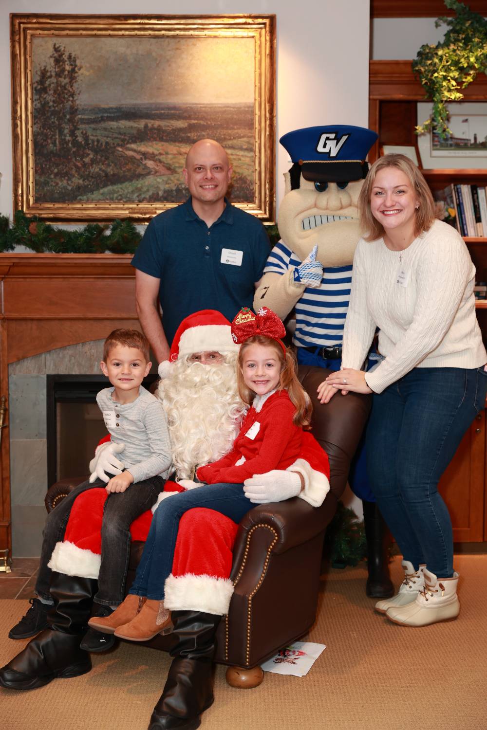 A family of four sitting with Santa.